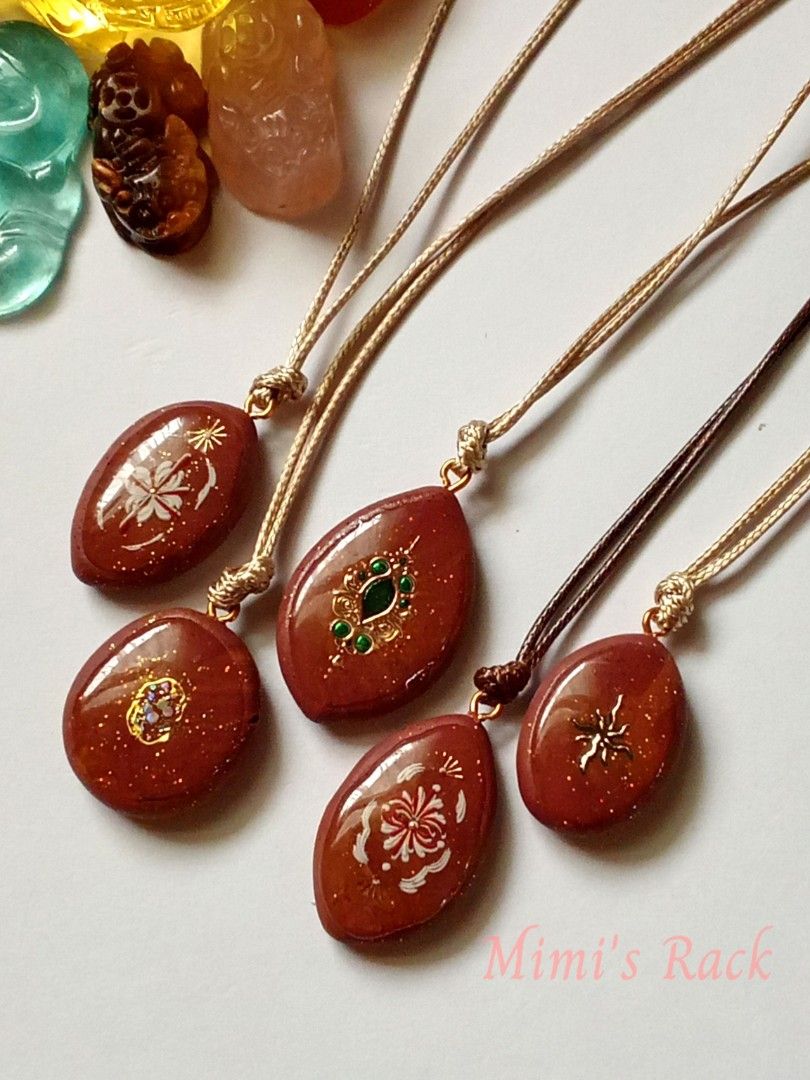 Reddish Brown Decoupage Pendant Rope Necklace (Category: Necklaces) located in Taguig. Submitted by mimisrack (Listing ID 1467530913, Image 2). Description: 🤎 Add a little vintage charm and sparkle to your everyday look! ✨ -These beautiful decoupage pendant necklaces feature a rich reddish-brown base, delicate floral and ornamental designs, gold glitter accents, and glossy finishes. Each pendant has its own unique design, from elegant floral pat