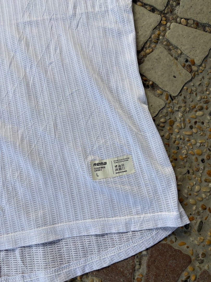 Rema Cloud Base Layer 4 Tank Top White (Category: Activewear) located in Iloilo. Submitted by raeshel (Listing ID 1467485511, Image 3). Description: Dimension : W 15.5’ L 23’ - Brand: Rema Cloud Base Layer 4 - Color: White - Size: L - Material: 93% recycled polyester, 7% recycled elastane - Fabric: Lightweight ribbed mesh, highly breathable activewear - Details: Printed text branding on chest and bottom hem label patch.