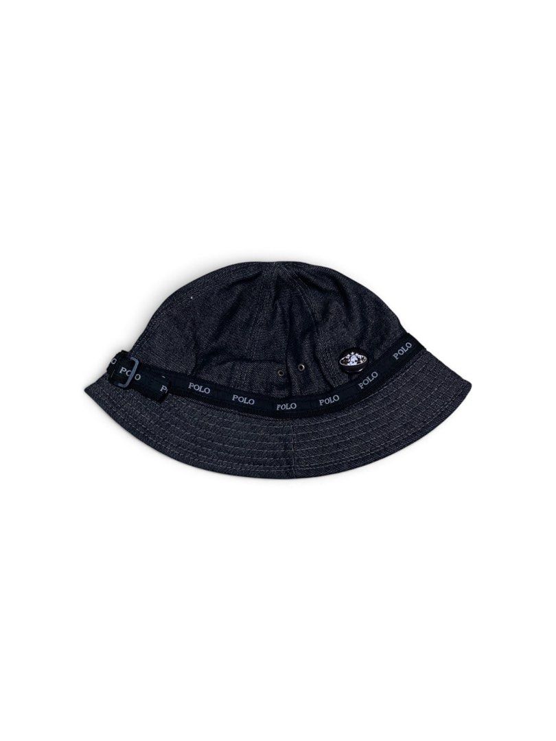 RL Polo Denim Bucket Hat (Category: Caps & Hats) located in Dagupan City. Submitted by 4kplug (Listing ID 1467377330, Image 1). Description: - Brand: Polo - Style: Dark denim bucket hat with a classic unstructured casual fit - Details: Black webbing strap with repeated white Polo branding - Hardware: Adjustable side metal buckle and a round black metal pin badge near the front - Comfort: Small eyelet vents on the crown for breathability - Conditi