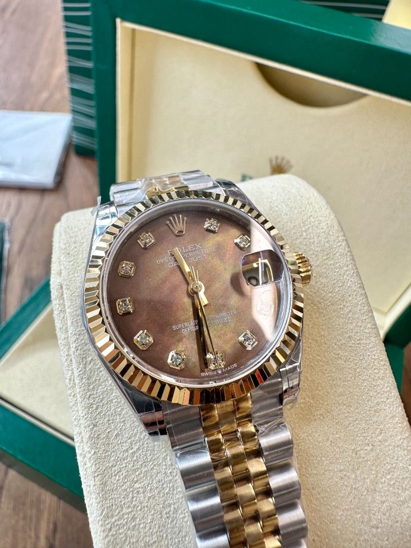 Rolex Datejust Two-Tone Diamond Dial Watch with Box (Category: Luxury Watches) located in Navotas City. Submitted by stevensmit50068 (Listing ID 1467438296, Image 2). Description: - Model: Rolex Datejust Two-Tone (Yellow Gold & Steel) - Bracelet: Jubilee bracelet with original protective plastic film still wrapped - Bezel: Iconic fluted yellow gold bezel - Dial: Brown sunburst or mother-of-pearl set with sparkling diamond hour markers - Crystal: 