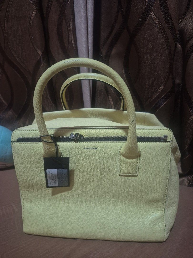 Rouge & Lounge Yellow Leather Handbag (Category: Luxury Bags & Wallets) located in Iloilo. Submitted by gorgeoustatz (Listing ID 1467521720, Image 1). Description: - Brand: Rouge & Lounge - Color: Bright yellow with black zipper and silver-tone hardware - Material: Textured pebbled leather with a structured silhouette - Closure: Secure black zipper with a leather pull tab - Condition: Clean stitching throughout, excellent quality.