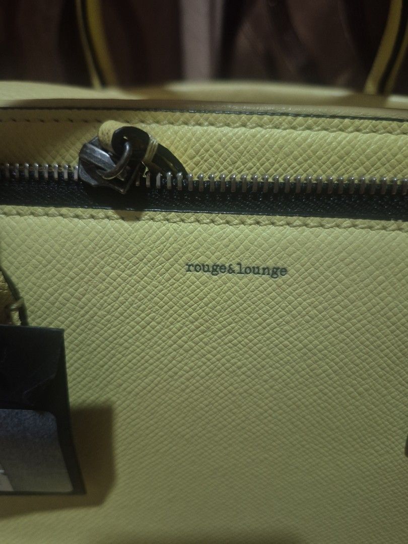 Rouge & Lounge Yellow Leather Handbag (Category: Luxury Bags & Wallets) located in Iloilo. Submitted by gorgeoustatz (Listing ID 1467521720, Image 2). Description: - Brand: Rouge & Lounge - Color: Bright yellow with black zipper and silver-tone hardware - Material: Textured pebbled leather with a structured silhouette - Closure: Secure black zipper with a leather pull tab - Condition: Clean stitching throughout, excellent quality.