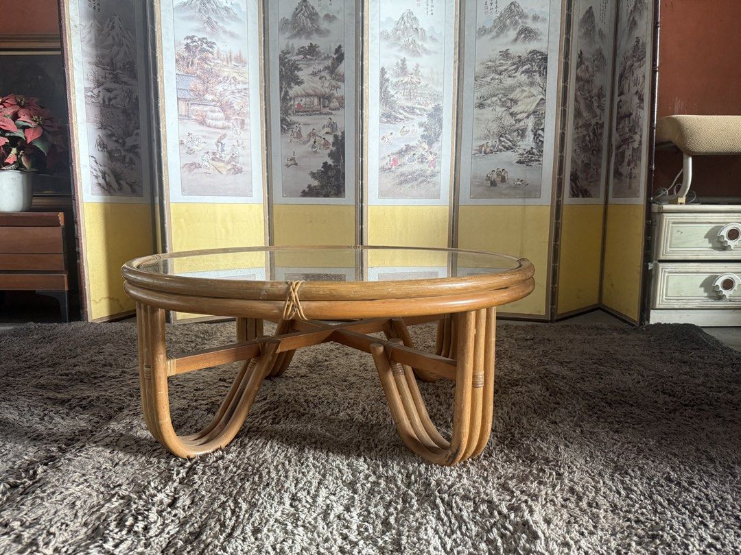 Round Rattan Coffee Table with Glass Top (Category: Tables & Sets) located in Angeles City. Submitted by maryannmar33098 (Listing ID 1467516009, Image 3). Description: - Material: Natural rattan, wicker, and clear glass top - Design: Unique curved loop legs with cross support beams for extra stability - Features: Lower woven shelf for storage or display - Condition: Very sturdy build, glass has no major scratches - Style: Perfect centerpiece for 