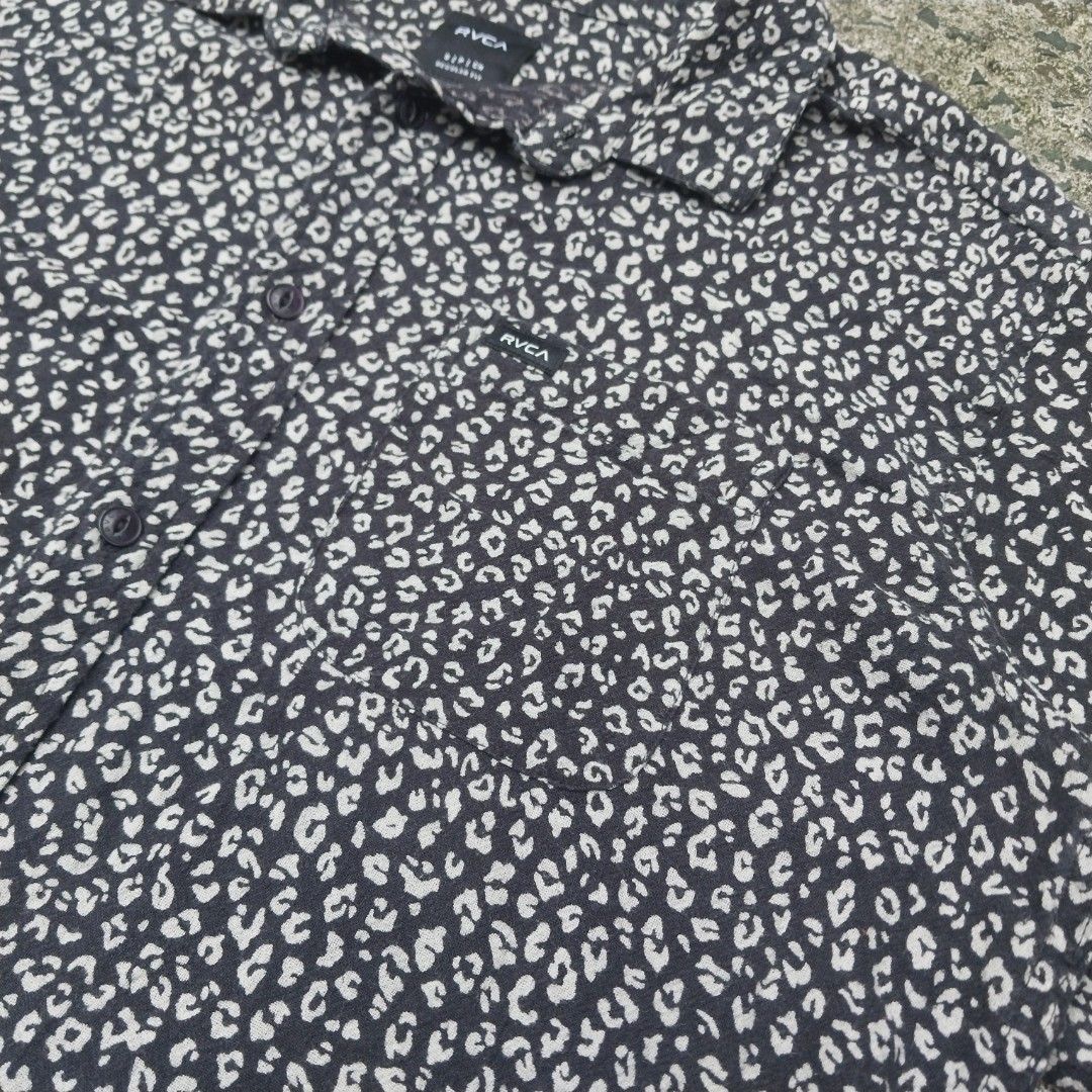 RVCA Leopard Print Short Sleeve Button Up (Category: Tshirts & Polo Shirts ) located in Cavite. Submitted by spinfits (Listing ID 1467556211, Image 3). Description: - Brand: RVCA - Style: Short sleeve button-up shirt - Pattern: Black and white leopard animal print - Size: Small (Regular fit) - Details: Left chest pocket with logo tag, branded buttons - Condition: Clean and ready to wear Size: S-M (Width: 20.5") (Lenght: 27") INCHES Condition: (Li