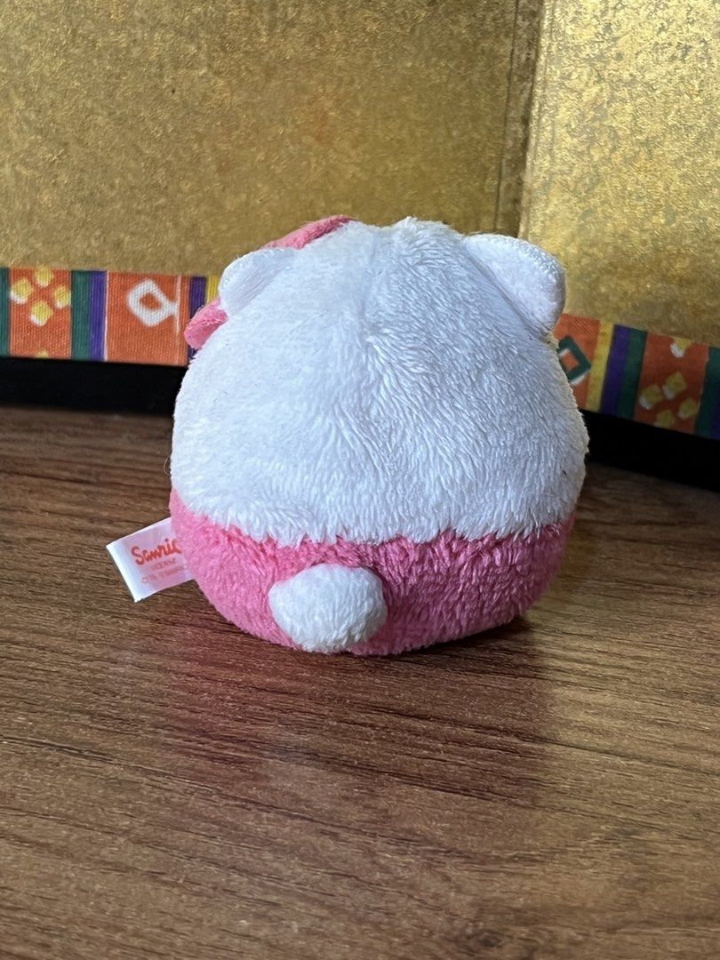 Sanrio Hello Kitty round plush pink and white (Category: Plushies & Soft Toys) located in Gapan. Submitted by lunashop14 (Listing ID 1467416048, Image 2). Description: - Authentic Sanrio Kitty round plush toy - Color: White top half, pink bottom half with golden embroidery - Features: Signature pink bow on the right ear and cute tail on the back - Authenticity: Official Sanrio license tag (dated 1976 and 2012) attached - Material: Ultra-soft and 