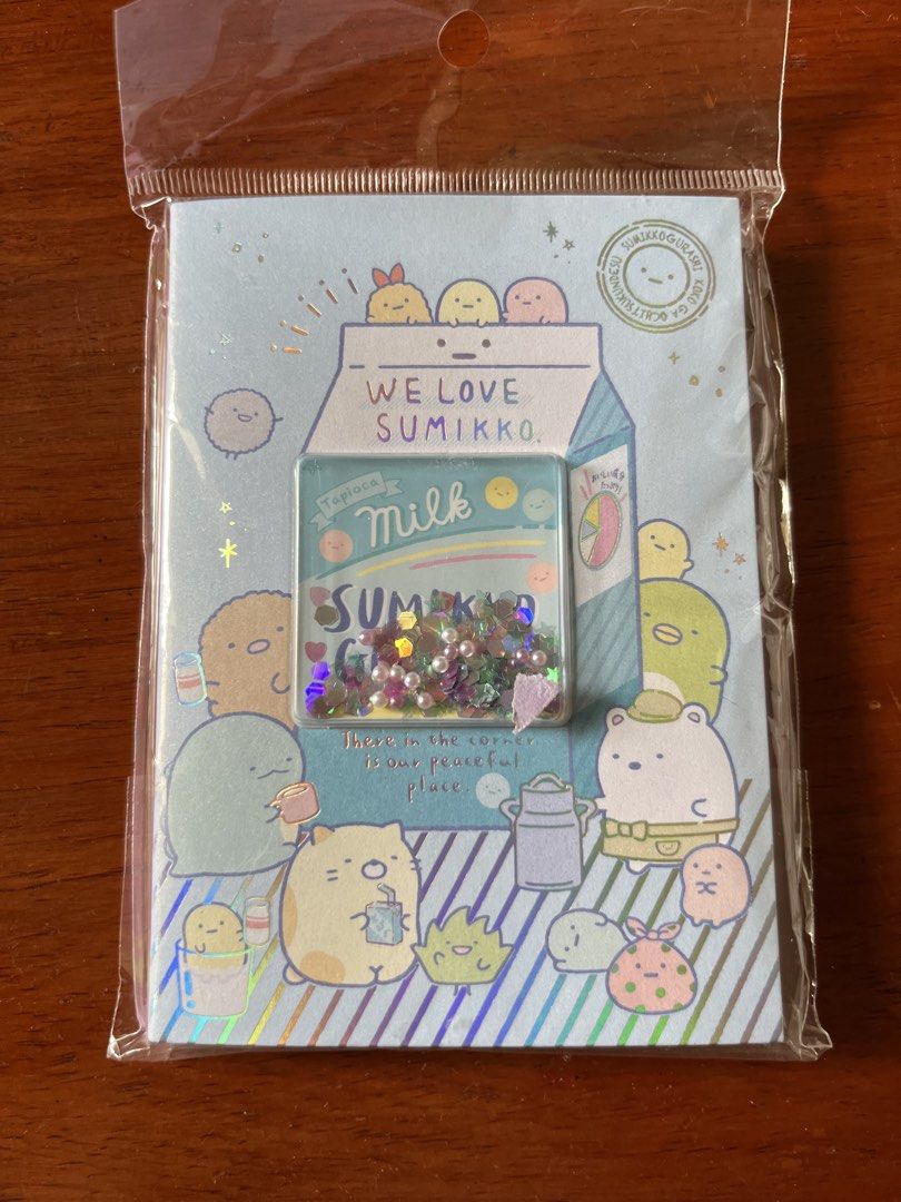 San-X Sumikkogurashi Memo Pad Notepad (Category: Stationery & School Supplies) located in Malolos. Submitted by mavi.annxo (Listing ID 1467387474, Image 1). Description: - Authentic San-X Sumikkogurashi 2023 collection - Brand new and still sealed in original plastic packaging - Adorable milk carton design with a clear shaker pocket filled with loose holographic stars and beads - Includes 80 total sheets featuring 2 cute inner note designs - Perf