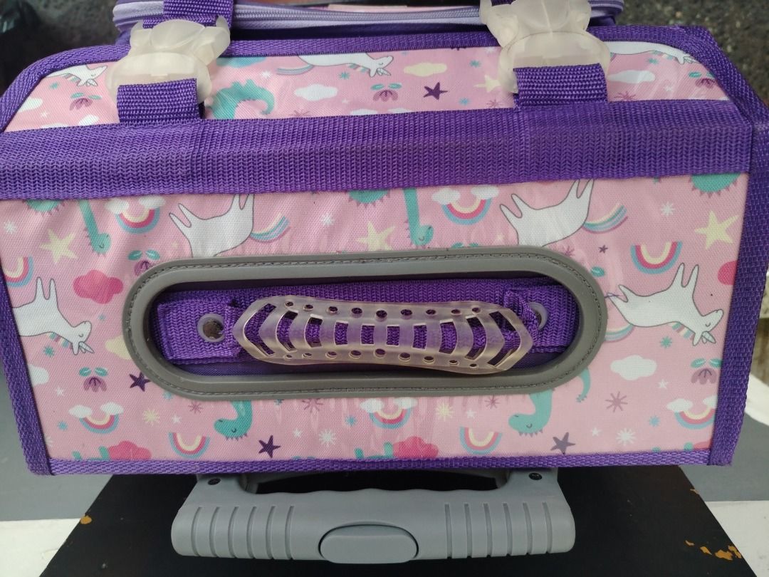 School bag (Category: Looking For) located in Pasig City. Submitted by cherryblossoms.2016 (Listing ID 1467523118, Image 2). Description: - Adorable pink and purple unicorn and rainbow all-over print - Convenient retractable top handle and sturdy carrying strap - Multiple zippered compartments to stay organized - Handy side pockets for water bottles - Durable plastic wheel base for smooth rolling - Includes a clear name tag slot on the front pock