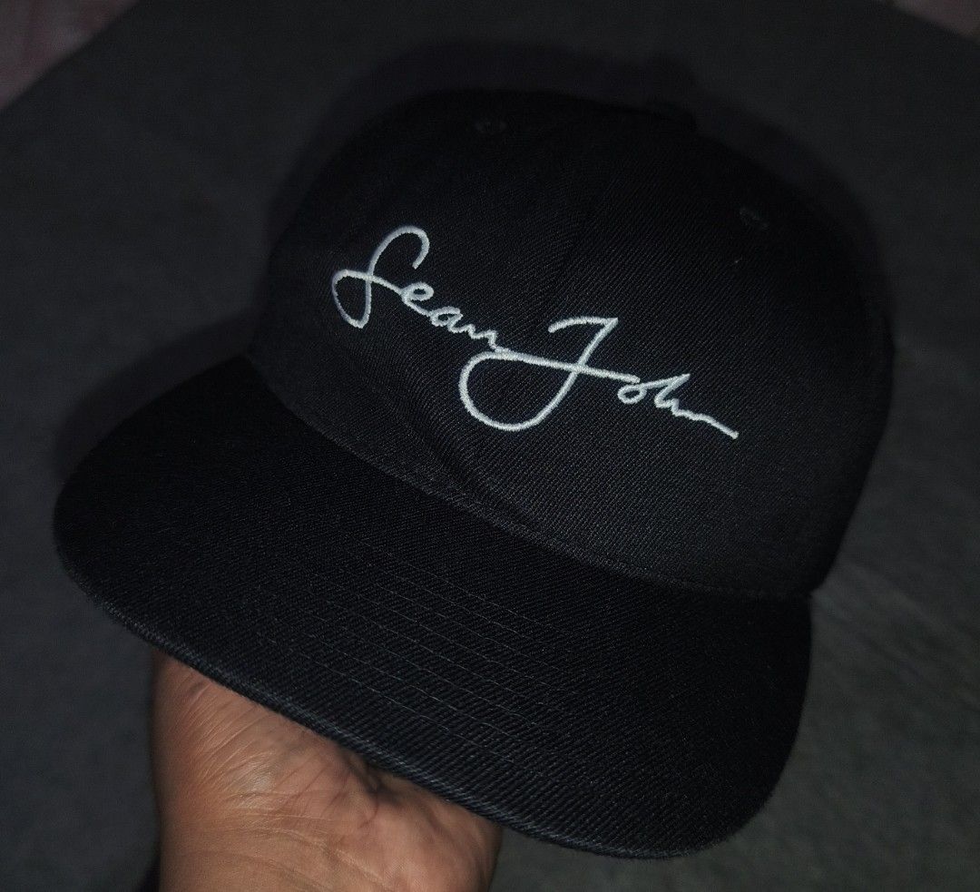 Sean John Flexfit Black Cap (Category: Caps & Hats) located in Cagayan de Oro. Submitted by elijah350below (Listing ID 1467516280, Image 1). Description: - Brand: Sean John - Color: Black with white embroidered script signature on front and small logo on back - Fit: Flexfit inner sweatband for a comfortable, snug fit - Material: 83% acrylic, 15% wool, 2% polyurethane spandex - Origin: Made in the Dominican Republic - Condition: good condition iss