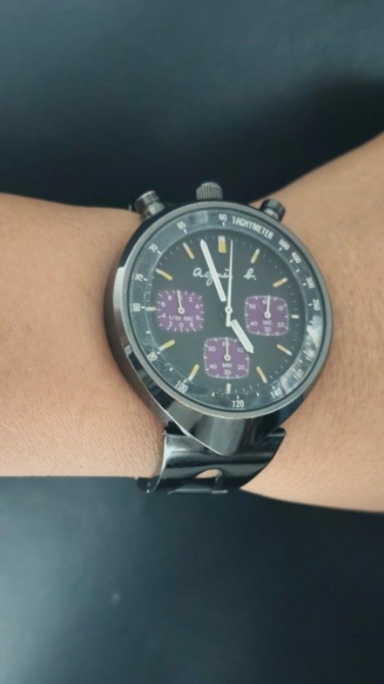 Seiko Agnes b.bullhead Chronograph Tachymeter Bezel Unisex Watch Japan (Category: Luxury Watches) located in Taguig. Submitted by mercyeugen28914 (Listing ID 1466291351, Image 1). Description: - Brand/Model: Preloved Agnes b. Watch Seiko - Material: Black stainless steel case and matching metal bracelet with signed clasp - Dial: Dark dial accented with striking purple subdials - Features: Tachymeter bezel and three side pushers - Condition: Shows