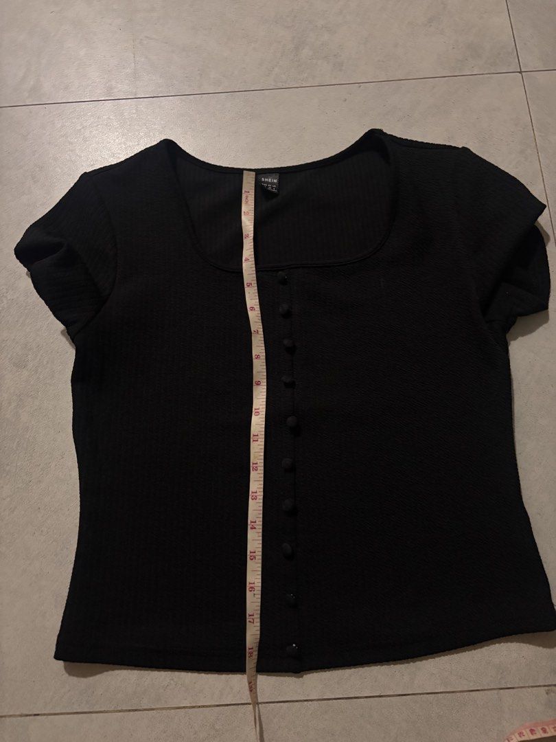 SHEIN Black Square Neck Button Front Top Size M (Category: Blouses) located in Manila. Submitted by nicoleaaa (Listing ID 1467454963, Image 2). Description: - Brand: SHEIN - Color: Black - Size: Medium - Style: Short-sleeve top with square neckline and decorative front buttons - Material: Textured fabric - Measurements: ~18" pit-to-pit, ~19" length - Condition: Excellent.