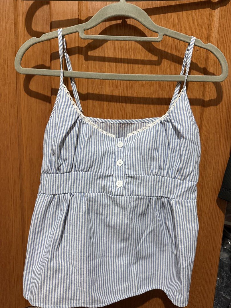 Shein Brandy inspired (Category: Sleeveless) located in Muntinlupa City. Submitted by biancaagbscloset (Listing ID 1467513616, Image 1). Description: - Blue and white vertical stripe cami top - Sweetheart neckline with delicate white lace trim - Functional front placket with three small white buttons - Flattering empire waist with gentle gathering - Thin, adjustable spaghetti straps for a custom fit - Lightweight, breathable fabric ideal for sunn