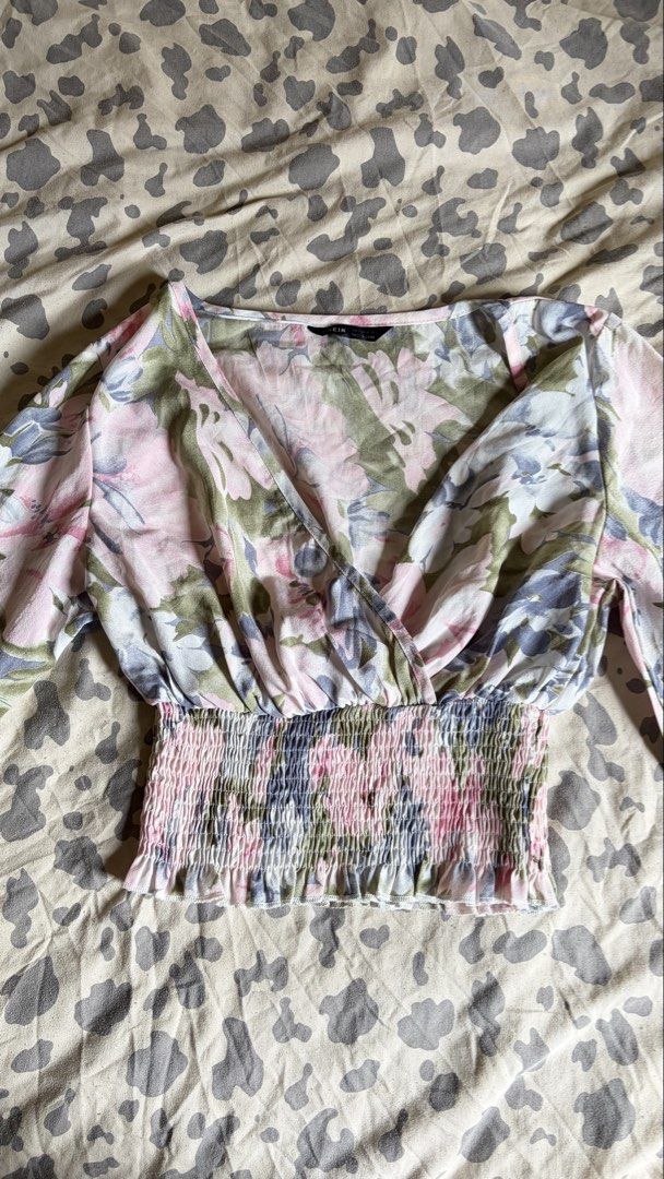 SHEIN Floral Print Wrap Crop Blouse (Category: Blouses) located in Malabon City. Submitted by ajaasmith (Listing ID 1467395975, Image 2). Description: - Brand: SHEIN - Size: US 4 - Condition: Worn once, like new - Design: Pink, green, and blue floral pattern - Style: V-neck wrap top with long sleeves, smocked waist, and smocked cuffs - Fabric: Super lightweight and comfortable Php 120.