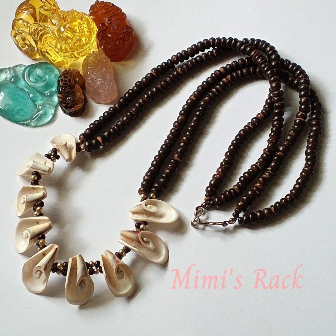 Shell and Wood Necklace (Category: Necklaces) located in Taguig. Submitted by mimisrack (Listing ID 1467436988, Image 1). Description: 🤎🐚A unique statement necklace featuring natural-looking dark wooden beads paired with beautiful cream and beige carved shell pendants. ✨ The intricate spiral designs add an artistic, earthy charm, while the gold-tone accent beads give it a subtle touch of elegance. 🧿 wood beads: 5mm 🧿 shell size: 12mm 🧿 neckl