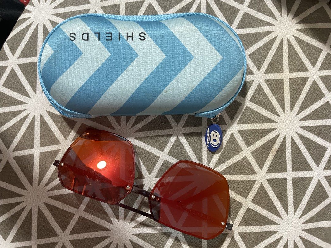 Shields Executive Optical Sunglasses with Case (Category: Sunglasses & Eyewear) located in Angono. Submitted by chachiron_ (Listing ID 1467373074, Image 3). Description: - Brand: Shields (from Executive Optical) - Condition: Clean and stored safely - Frame: Metal frames with tinted lenses - Fit: Standard sizing, comfortable for daily wear - Inclusions: Matching blue chevron hard case with EO zipper pull - Perfect as an everyday go-to pair of sung