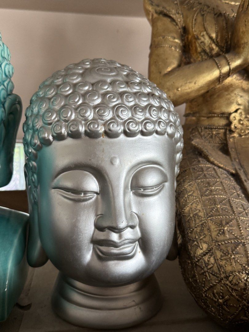 Silver Buddha Head Statue Asian Decor (Category: Figurines & Statues) located in Manila. Submitted by chestercor71092 (Listing ID 1467434419, Image 1). Description: - Silver Buddha head statue with classic ushnisha curls and peaceful closed eyes - Smooth metallic silver finish with a sturdy, flared base pedestal - Shows minor light wear spots near the forehead and cheek area - Heavy decorative piece that adds a calm, serene vibe to any room - Ide