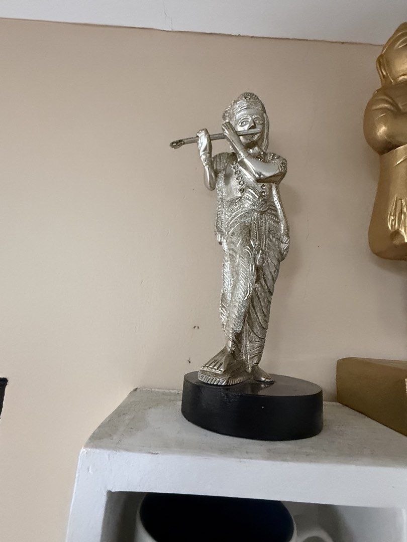 Silver Lord Krishna Playing Flute Figurine Statue (Category: Figurines & Statues) located in Manila. Submitted by chestercor71092 (Listing ID 1467435150, Image 1). Description: - Silver-finished statue of Lord Krishna playing the flute - Features detailed traditional attire, jewelry, and headdress - Mounted on a sturdy, solid black oval base - Ideal size and weight for shelf or altar display - Clean, well-maintained piece kept indoors.
