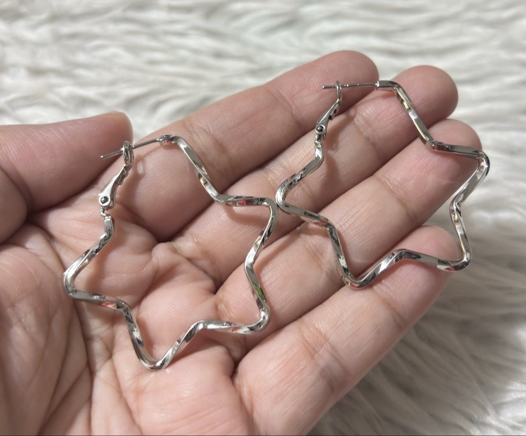 Silver-toned star shaped wavy hoop earrings (Category: Earrings) located in Paranaque City. Submitted by dalle_closet (Listing ID 1467393566, Image 2). Description: like new pa with markings siya. hindi ko lang mabasa.