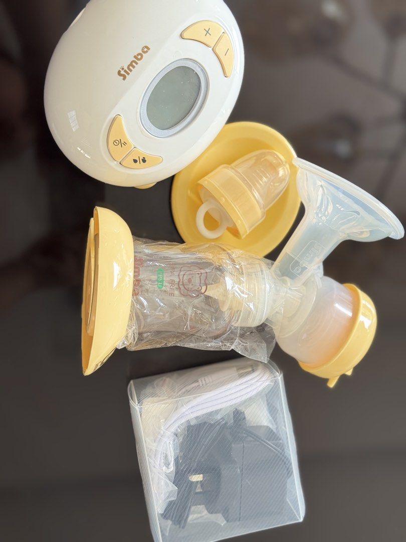 Simba Electric Breast Pump Set with Accessories (Category: Breastfeeding & Bottle Feeding) located in Manila. Submitted by rheylou28 (Listing ID 1467444710, Image 1). Description: - Brand: Simba electric breast pump - Features: Digital display screen and easy-to-use control buttons - Color: Cheerful yellow and white scheme - Inclusions: Pump motor, collection bottle with protective wrapping, funnel attachment, silicone tubing, power adapter plug,