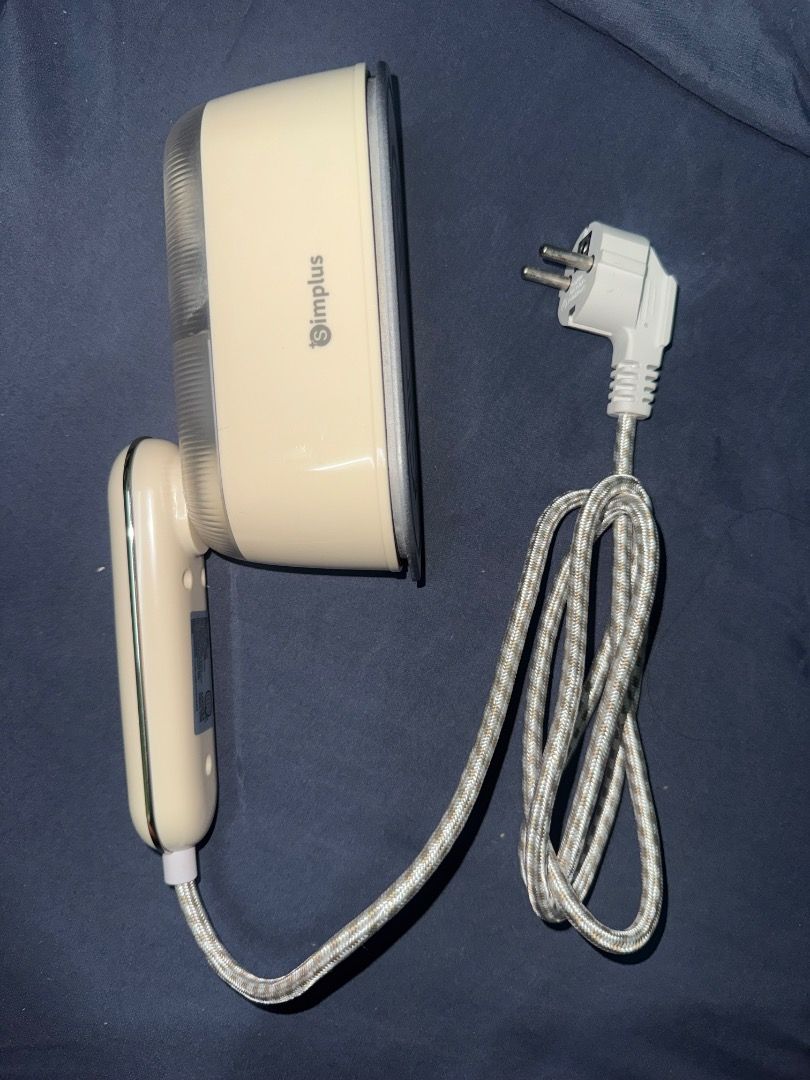 Simplus 2 in 1 Steam Iron GTJH022 (Category: Irons & Steamers) located in Makati City. Submitted by reveblinkqueue (Listing ID 1467566833, Image 2). Description: - Model: Simplus 2-in-1 Steam Iron and Garment Steamer - Color: Cream White - Function: Supports both wet and dry ironing - Design: Portable size with a convenient foldable handle, great for travel and home storage - Capacity: 140ml water tank - Cord: Durable woven patterned finish with 