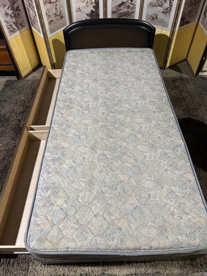Single bed frame with mattress and under-bed storage drawers (Category: Bed Frames & Mattresses) located in Angeles City. Submitted by maryannmar33098 (Listing ID 1467512497, Image 3). Description: - Dark wood single bed frame in sturdy condition - Includes a comfortable, perfectly fitted patterned mattress - Features two large pull-out drawers underneath for extra storage - Stylish curved headboard design - Excellent space saver for apartments, 