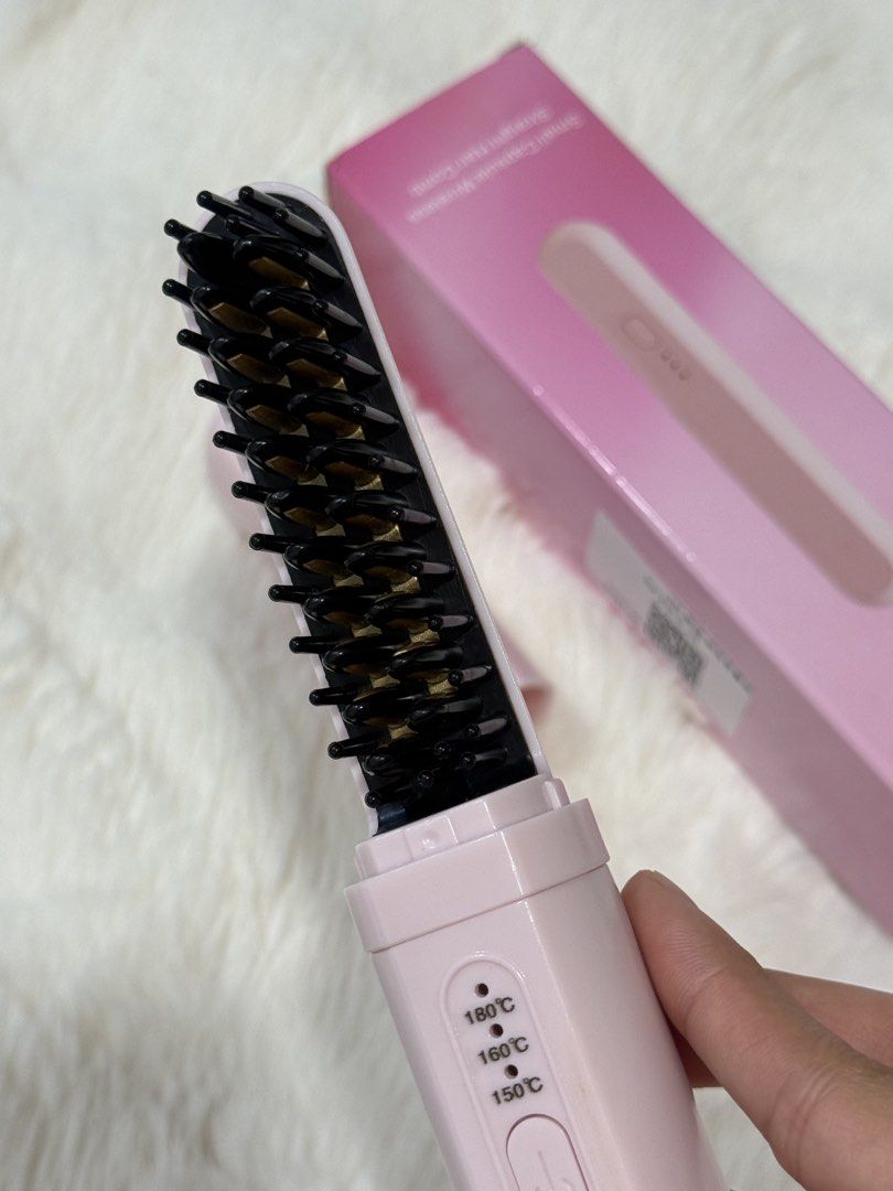 Small Capsule Wireless Straight Hair Comb Pink (Category: Hair Accessories) located in Manila. Submitted by preshyyyyy_ (Listing ID 1467563796, Image 3). Description: - Color: Pastel Pink - Type: Wireless straight hair comb / capsule styler - Portability: Compact size, ideal for travel and everyday bag carry - Heat Settings: 3 levels (150°C to 180°C) with blue indicator lights - Inclusion: Matching pink storage box - Condition: Fully operational 