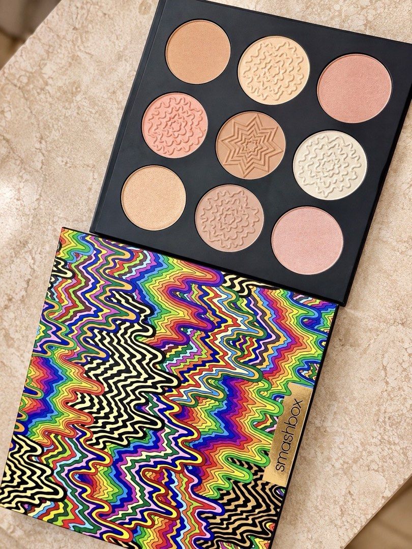 Smashbox Halo Glow Highlight Palette (Category: Makeup) located in Manila. Submitted by globetrotter143 (Listing ID 1467451401, Image 1). Description: - Brand: Smashbox - Shades: 9 metallic, shimmer, and golden bronze highlight tones - Condition: Brand new, untouched powders with clean surface - Design: Pans feature embossed swirl and star patterns - Packaging: Vibrant rainbow outer cover with a stylish gold logo accent - Perfect for creating a r