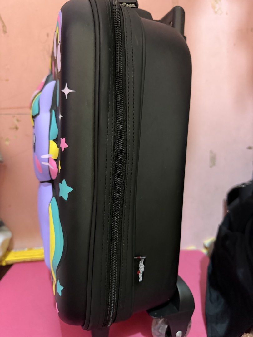 Smiggle Unicorn Cat Hard Shell Rolling Luggage Suitcase (Category: Luggage) located in Manila. Submitted by shielamar05615 (Listing ID 1467372464, Image 2). Description: - Authentic Smiggle rolling suitcase in classic black - Adorable raised purple unicorn cat design with a rainbow horn, colourful mane, and stars - Features a smooth telescopic handle and sturdy bottom wheels for easy travel - Secure side zip closure and convenient back pocket fla
