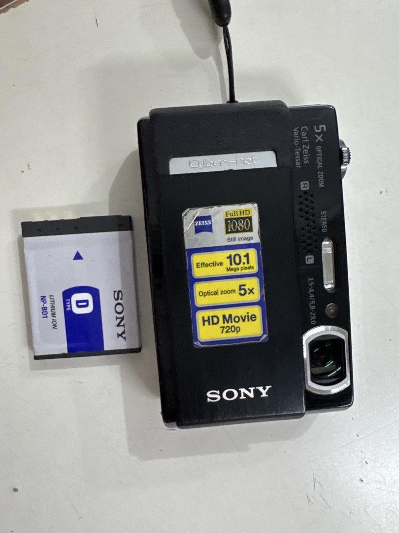 Sony Cyber-shot Digital Camera with NP-BD1 Battery (Category: Cameras) located in Legazpi City. Submitted by angelamedalla (Listing ID 1467526190, Image 1). Description: - Model: Sony Cyber-shot Digital Camera (Black) - Optics: Carl Zeiss Vario-Tessar lens with 5x optical zoom - Resolution: 10.1 megapixels with Full HD still image capability - Battery: Includes original Sony NP-BD1 lithium-ion battery - Condition: Powers up nicely, with minor cos