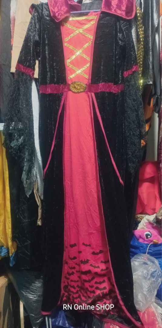 Spooktacular Creations Royal Vampire Costume (Category: Babies & Kids Fashion) located in Caloocan City. Submitted by rb_17 (Listing ID 1467579644, Image 2). Description: - Estimated size can fit to 11-12uears old slim body or xs adult Brand: Spooktacular Creations - Style: Royal vampire costume dress - Material & Design: Black velvet with striking pink and gold accents - Key Features: High standing collar, chest criss-cross detail, laced mesh sl