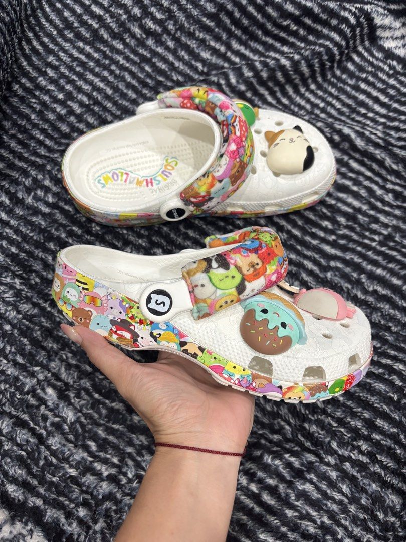 Squishmallows x Crocs Classic Clog White Multi (Category: Slippers and slides) located in Digos. Submitted by kathydiane76376 (Listing ID 1467518853, Image 3). Description: - Authentic Special Edition Squishmallows x Crocs collaboration - Color/Design: White base with vibrant all-over character print - Features cozy fuzzy heel straps covered in mini characters - Comes with cute pre-attached Jibbitz charms (cat, duck, ice cream designs) - Original