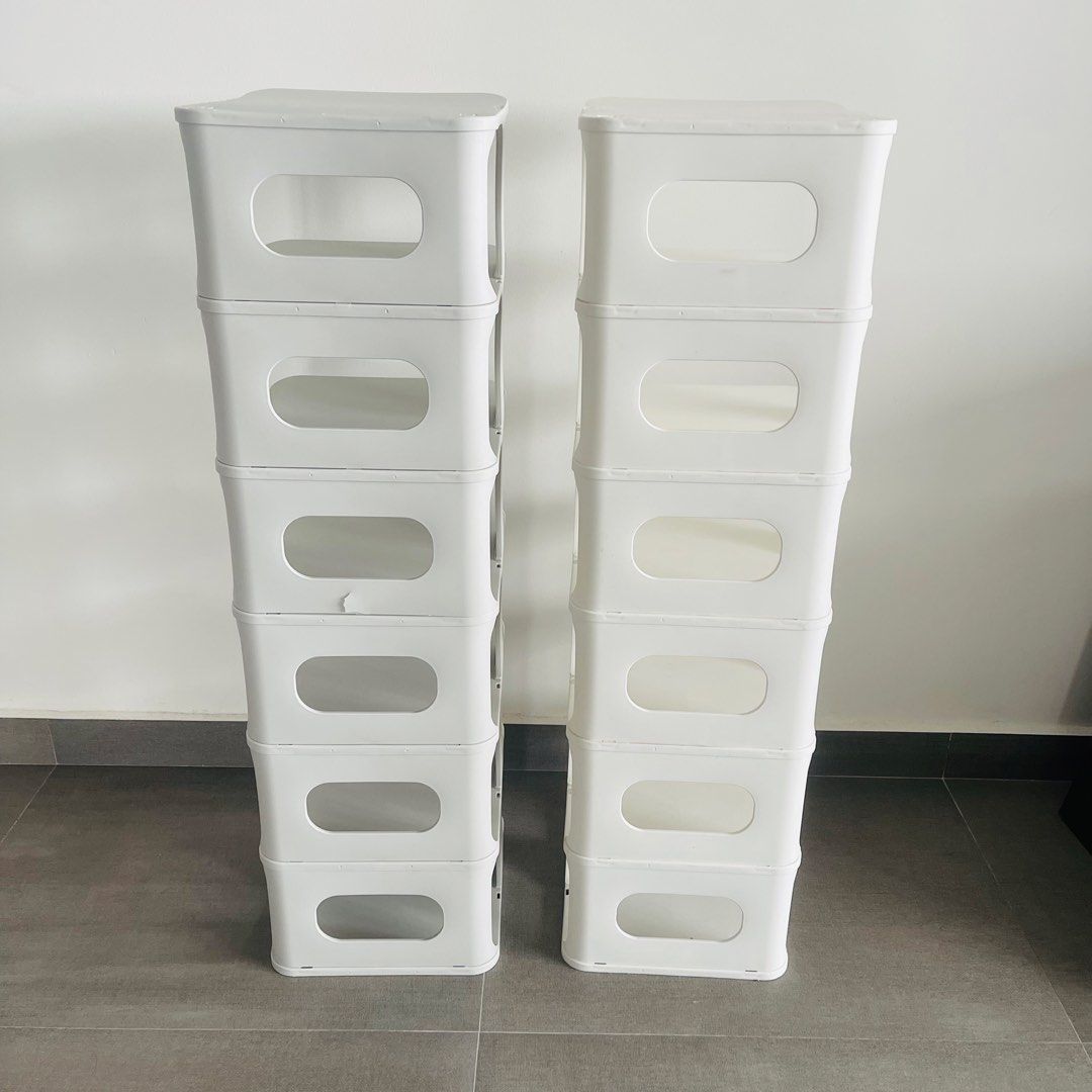 Stackable plastic shoe rack (Category: Shelves, Cabinets & Racks) located in Singapore. Submitted by apr1l (Listing ID 1467399366, Image 3). Description: Selling white at $7 Selling Grey at $6 Buy both for $10 - 2 shoe rack for sale - one White & one Grey - 7 tiers per rack for maximum entryway storage - Sturdy and reliable construction - Minor crack near the edge on grey rack at the back (shown in close-up photo) Condition: 9/10 Lightly used. Gr