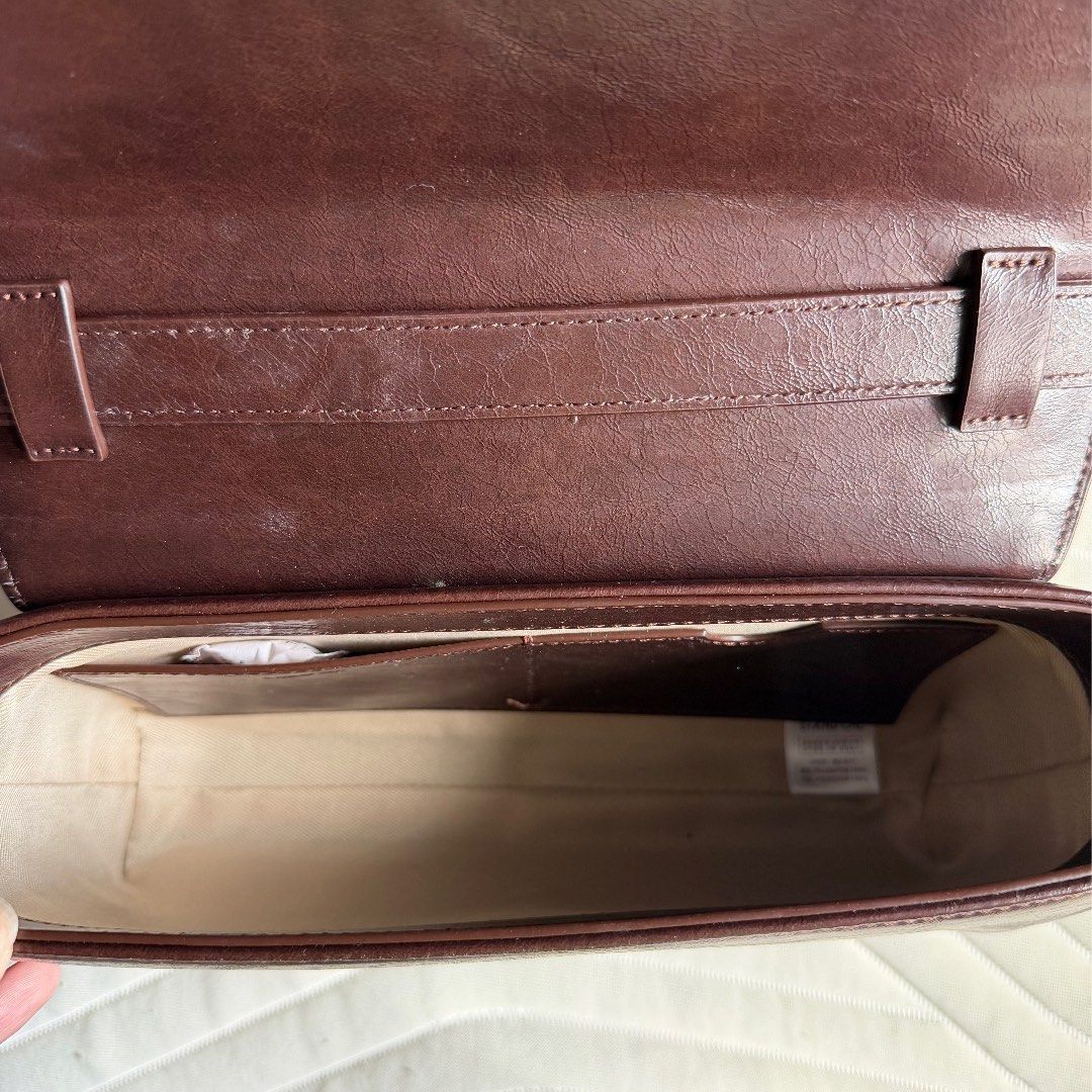 Stand Oil Dark Brown Shoulder Bag (Category: Shoulder Bags) located in Manila. Submitted by jlssntg (Listing ID 1467400065, Image 2). Description: - Brand: Stand Oil - Color: Dark brown - Closure: Flap with magnetic snap - Interior: Clean lining with a slip pocket - Strap: Long and adjustable - Inclusions: Original white dust bag with printed logo - Condition: Excellent, clean interior.