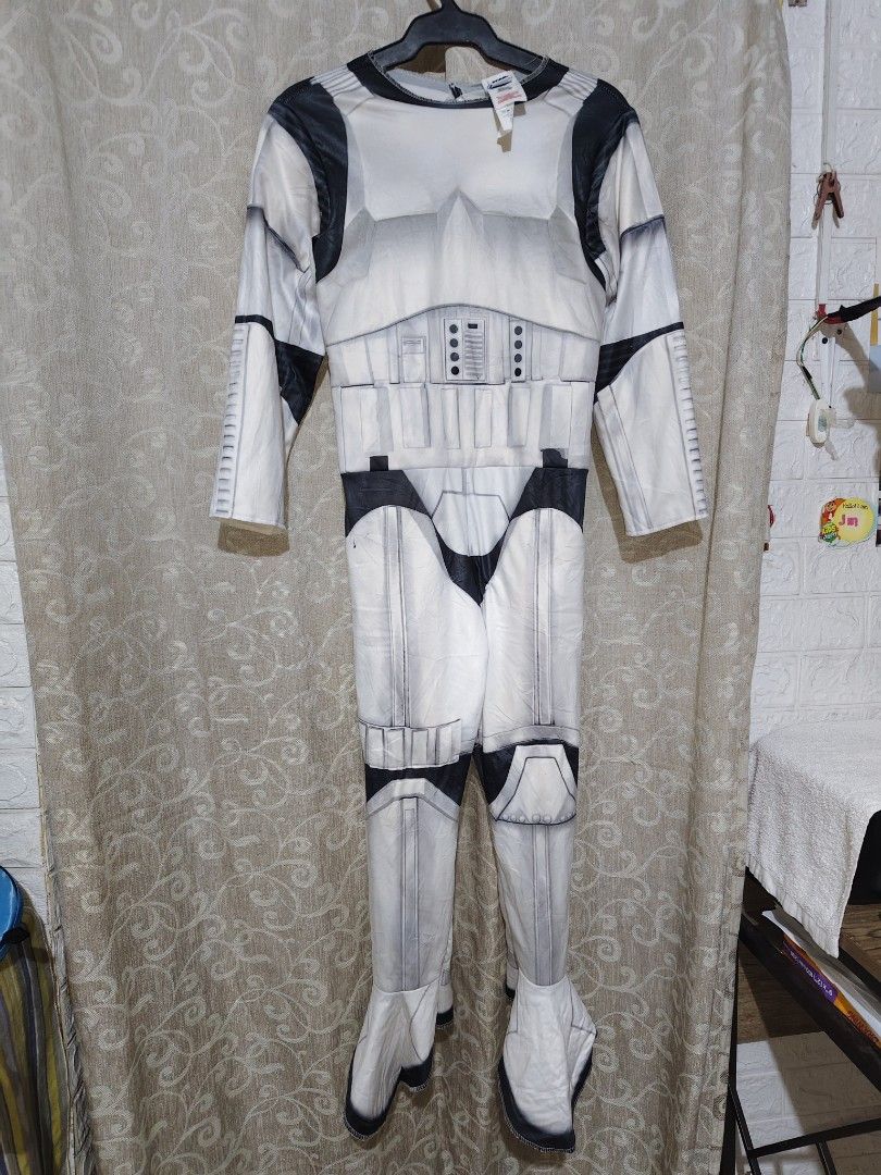 Star Wars Costume, with Mask, Stormtrooper Costume Jumpsuit (Category: Kids Wardrobes & Storage) located in Manila. Submitted by duffy-080 (Listing ID 1467406196, Image 1). Description: - Official Star Wars Stormtrooper costume jumpsuit - Size M (tag attached) - Classic white and black printed armor details on front and back - Includes long sleeves and built-in shoe covers - Made in China (Warning: Keep away from fire) -Bust 38cm for kids -waist 