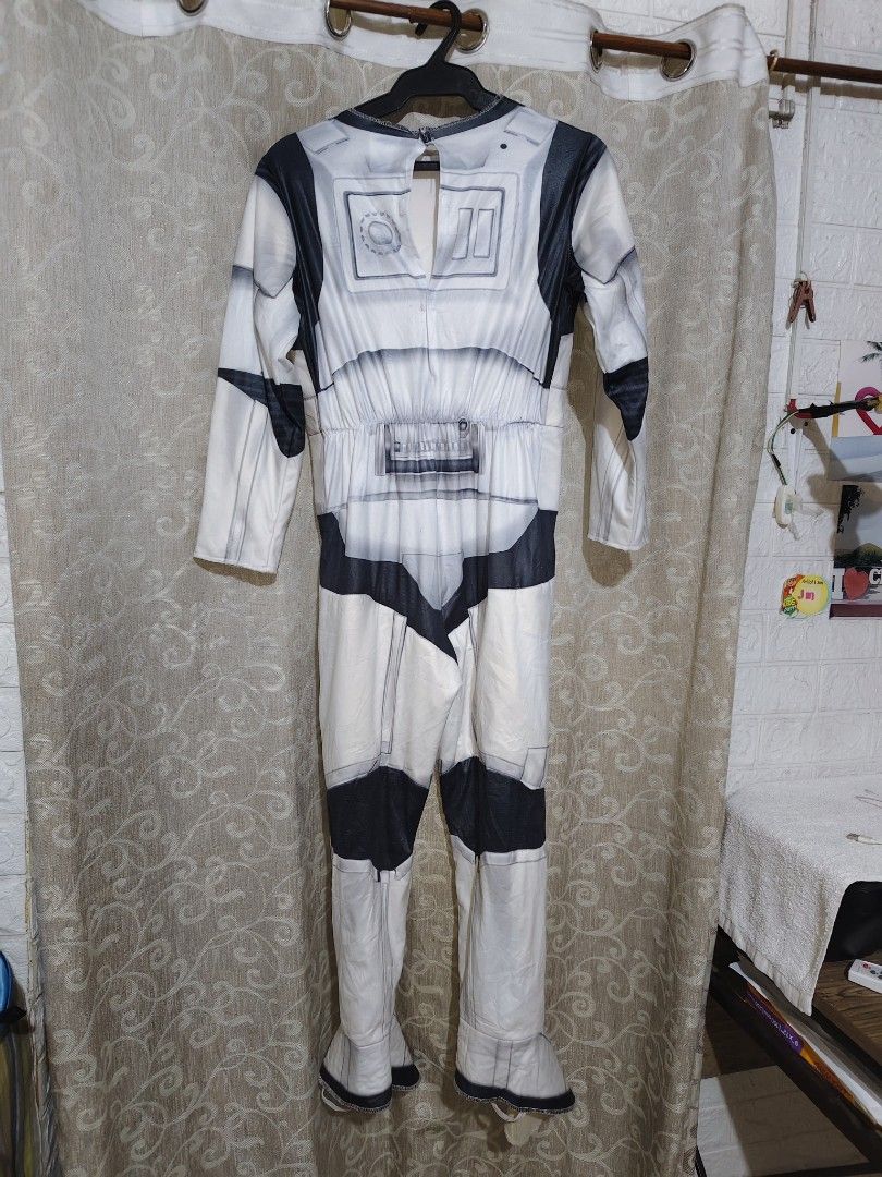 Star Wars Costume, with Mask, Stormtrooper Costume Jumpsuit (Category: Kids Wardrobes & Storage) located in Manila. Submitted by duffy-080 (Listing ID 1467406196, Image 3). Description: - Official Star Wars Stormtrooper costume jumpsuit - Size M (tag attached) - Classic white and black printed armor details on front and back - Includes long sleeves and built-in shoe covers - Made in China (Warning: Keep away from fire) -Bust 38cm for kids -waist 