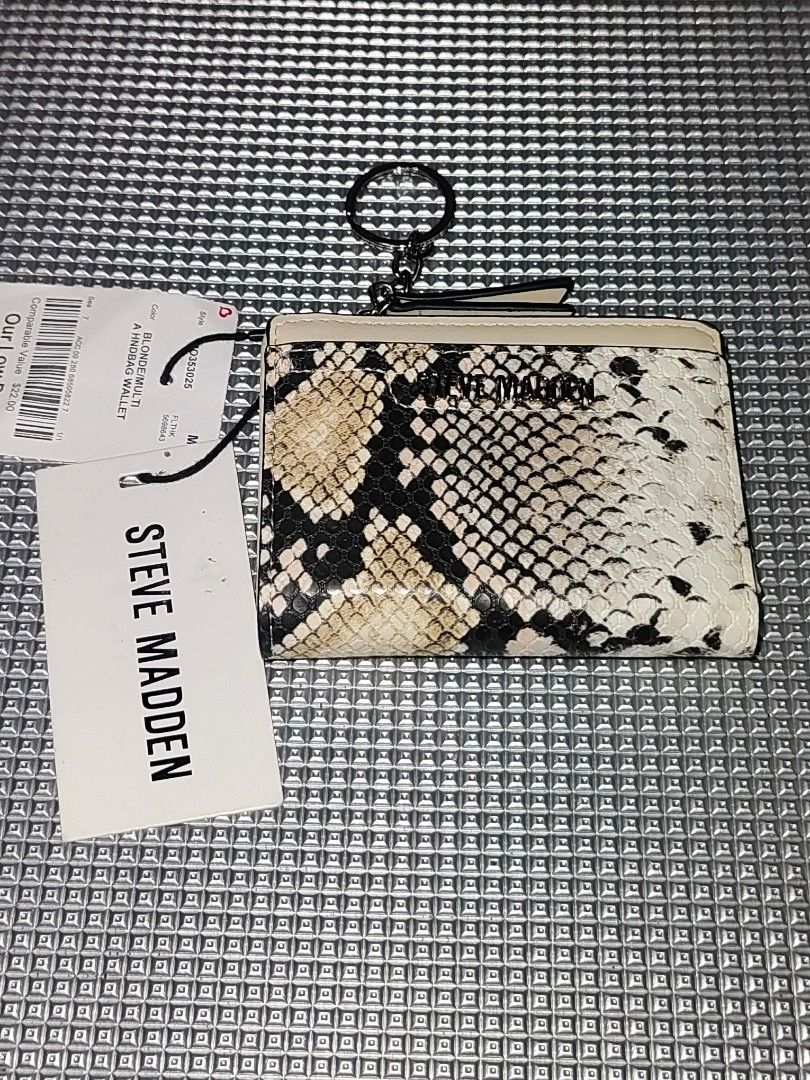 Steve Madden Snake Print Wallet (Category: Wallets & Card holders) located in Cavite. Submitted by mahthriftshop (Listing ID 1467378717, Image 2). Description: - Brand: Steve Madden - Condition: Brand new with original store tags attached - Design: Bi-fold small wallet with snake print in blonde multi - Features: Card slots, ID window, and secure zip pocket - Extra: Attached keychain ring at the top for convenience.