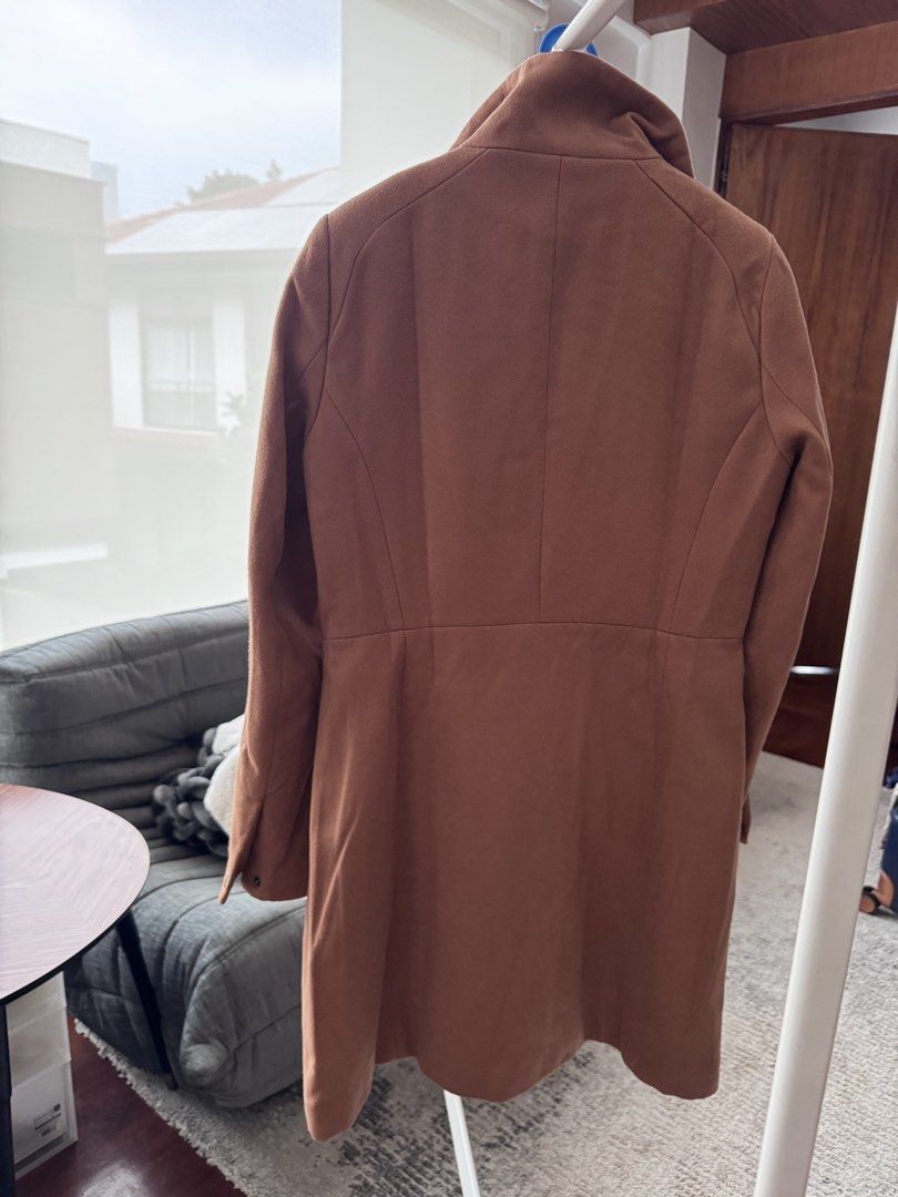 Stradivarius Camel Long Coat Size M (Category: Coats, Jackets and Outerwear) located in Pasig City. Submitted by abe_salazar_1981 (Listing ID 1467514804, Image 3). Description: - Brand: Stradivarius - Style: Wool-blend coat - Color: Camel - Size: Medium - Details: High standing collar, zip side pockets, front button closure with hidden placket, black quilted inner lining, and structured waist - Condition: Clean, no tears or stains.