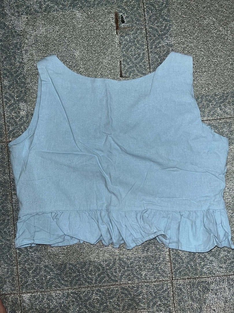 Strut in Style Light blue crop top with ruffled hem (Category: Sleeveless) located in Manila. Submitted by rhiangastadora (Listing ID 1467507238, Image 2). Description: - Color: Light blue - Style: Sleeveless crop top with scoop neckline and ruffled hem - Material: Lightweight and comfortable fabric - Condition: Excellent, no flaws, ready to wear.