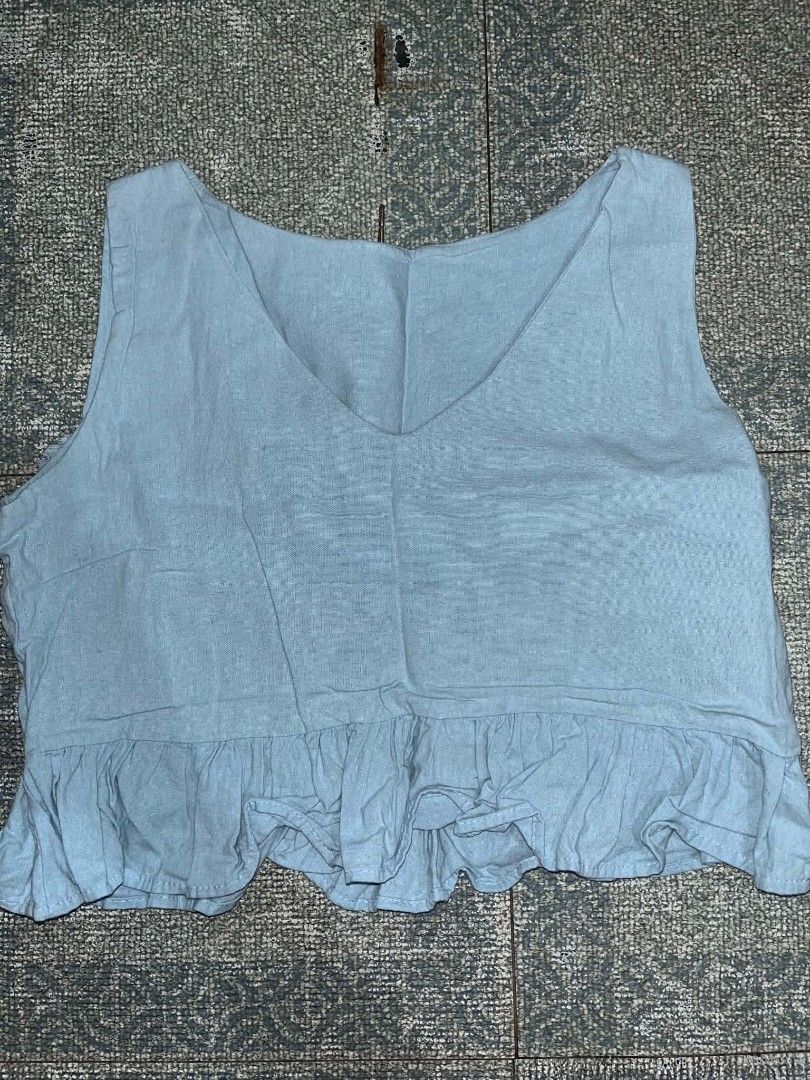 Strut in Style Light blue crop top with ruffled hem (Category: Sleeveless) located in Manila. Submitted by rhiangastadora (Listing ID 1467507238, Image 1). Description: - Color: Light blue - Style: Sleeveless crop top with scoop neckline and ruffled hem - Material: Lightweight and comfortable fabric - Condition: Excellent, no flaws, ready to wear.
