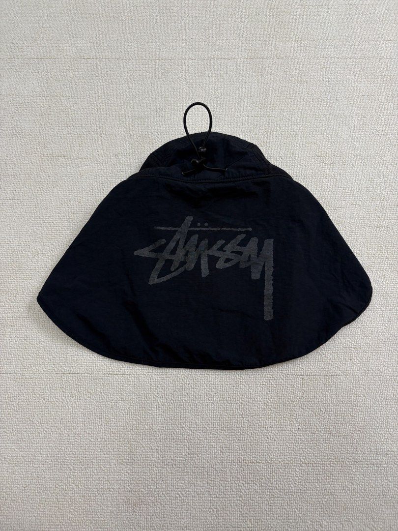 Stussy Black Cap with Neck Flap (Category: Caps & Hats) located in Manila. Submitted by porma.market (Listing ID 1467404137, Image 3). Description: - 100% Authentic Stussy black cap - Detachable neck flap with printed logo - Breathable side mesh panels - Adjustable toggle cord at the back for a custom fit - Classic embroidered Stussy logo - Size: OS (57cm) - Condition: Clean inside and out.