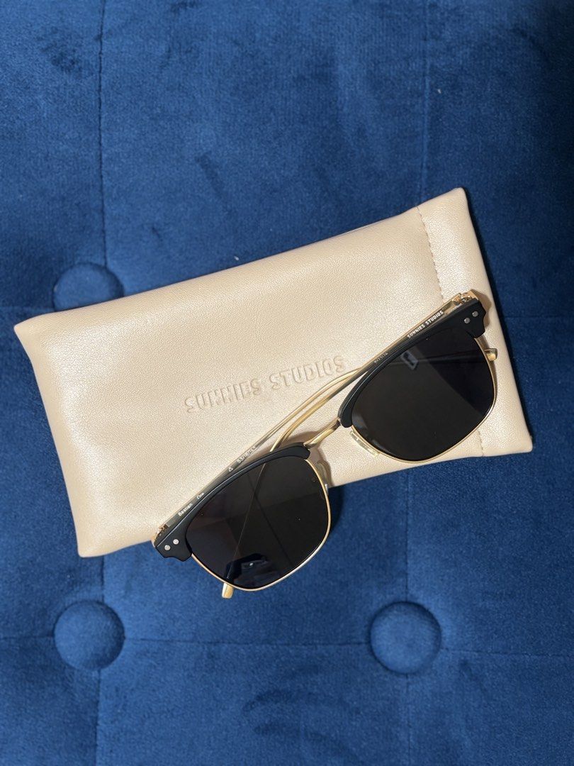 Sunnies Studios Bastian Sunglasses (Category: Sunglasses & Eyewear) located in Quezon City. Submitted by declutternstuff (Listing ID 1467515259, Image 1). Description: - Brand: Sunnies Studios - Model: Bastian - Colorway: Black and gold - Frame Style: Semi-rimless browline with dark tinted lenses - Sizing: Standard adult - Condition: Clean, minimal signs of handling - Inclusions: Official matching cream-colored soft case with embossed branding - 