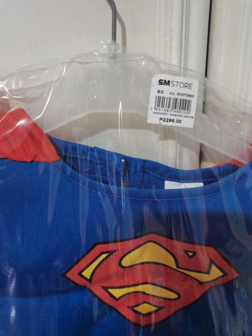 Superman Costume Kids (Category: Babies & Kids Fashion) located in Lucena. Submitted by jjbrandedcloset (Listing ID 1467381124, Image 2). Description: - Brand new, never opened or worn - Still sealed in original SM Store plastic wrapper - Original price tag of ₱2,299 attached - Includes blue top with classic red and yellow Superman logo - Attached red cape included - Features printed belt detail and matching red pants.