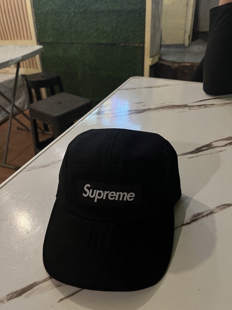 Supreme Black 5-Panel Camp Cap (Category: Caps & Hats) located in Impasugong. Submitted by luisterpicks (Listing ID 1467485745, Image 1). Description: - Authentic black Supreme camp cap - Iconic white embroidered box logo on front - Adjustable strapback closure with branded plastic buckle - Clean condition with minimal signs of wear - Perfect for daily streetwear and casual fits.
