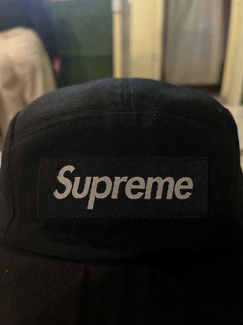 Supreme Black 5-Panel Camp Cap (Category: Caps & Hats) located in Impasugong. Submitted by luisterpicks (Listing ID 1467485745, Image 2). Description: - Authentic black Supreme camp cap - Iconic white embroidered box logo on front - Adjustable strapback closure with branded plastic buckle - Clean condition with minimal signs of wear - Perfect for daily streetwear and casual fits.