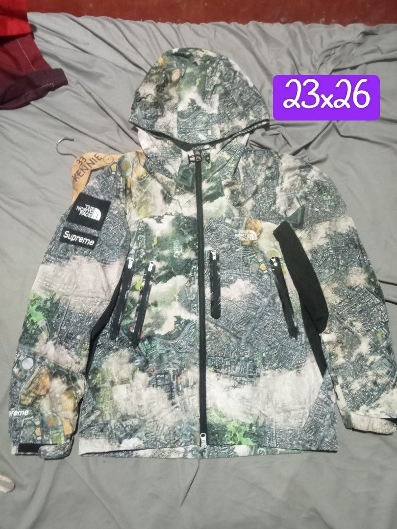 Supreme The North Face Aerial Tapestry Jacket (Category: Coats, Jackets and Outerwear) located in Sagay. Submitted by kennie_3377 (Listing ID 1467417395, Image 1). Description: Supreme and The North Face collaboration jacket. Aerial map city print across the entire piece. Size small. Zipper pockets on the front. Double branding patches on the sleeve and inside collar. Tag shows model number NP618677. Inner lining has a silver dot pattern..