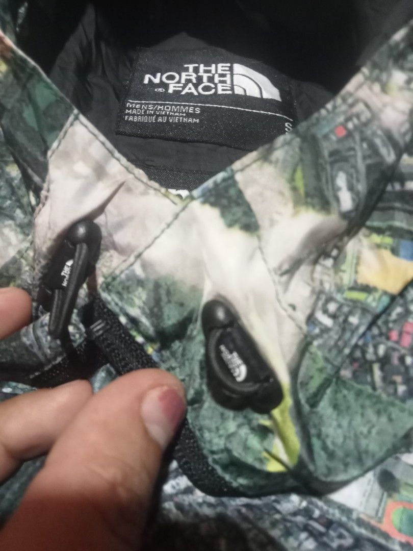 Supreme The North Face Aerial Tapestry Jacket (Category: Coats, Jackets and Outerwear) located in Sagay. Submitted by kennie_3377 (Listing ID 1467417395, Image 3). Description: Supreme and The North Face collaboration jacket. Aerial map city print across the entire piece. Size small. Zipper pockets on the front. Double branding patches on the sleeve and inside collar. Tag shows model number NP618677. Inner lining has a silver dot pattern..