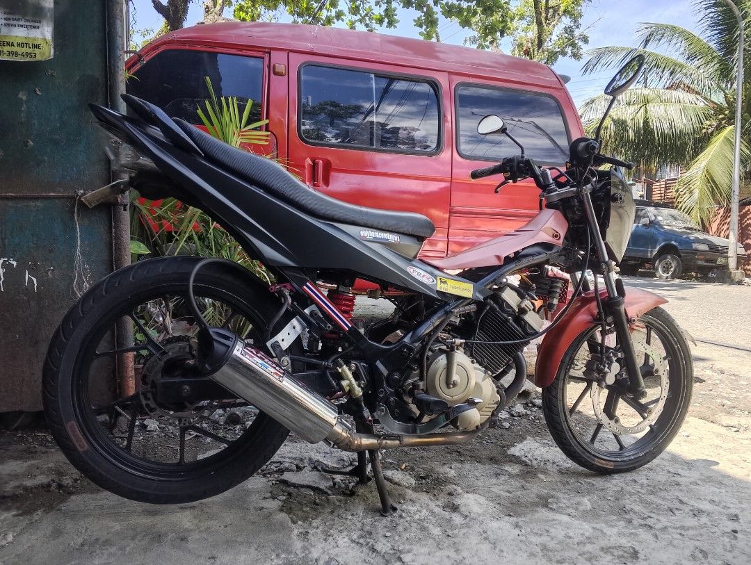 Suzuki Raider 150 Underbone Motorcycle (Category: Motorbikes for Sale) located in Iligan City. Submitted by jerry.c2006 (Listing ID 1467468239, Image 1). Description: Suzuki Raider 150 underbone motorcycle. Black and red color scheme with gold engine accents. Custom exhaust pipe installed. Black alloy wheels and slim profile tires. Clean body frame setup. Runs well, reliable daily commuter or project bike base. Ready to ride..