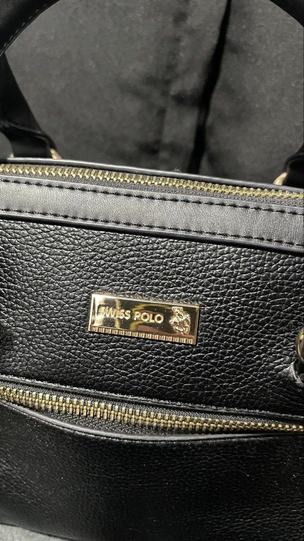 Swiss polo black shoukder bag (Category: Shoulder Bags) located in Baliuag. Submitted by sirc_28 (Listing ID 1467411405, Image 2). Description: This is a Swiss Polo Ladies Top Handle Sling Bag in black, featuring a textured faux leather (PVC leather) finish, twin top handles, gold-tone hardware, and a front zippered pocket.