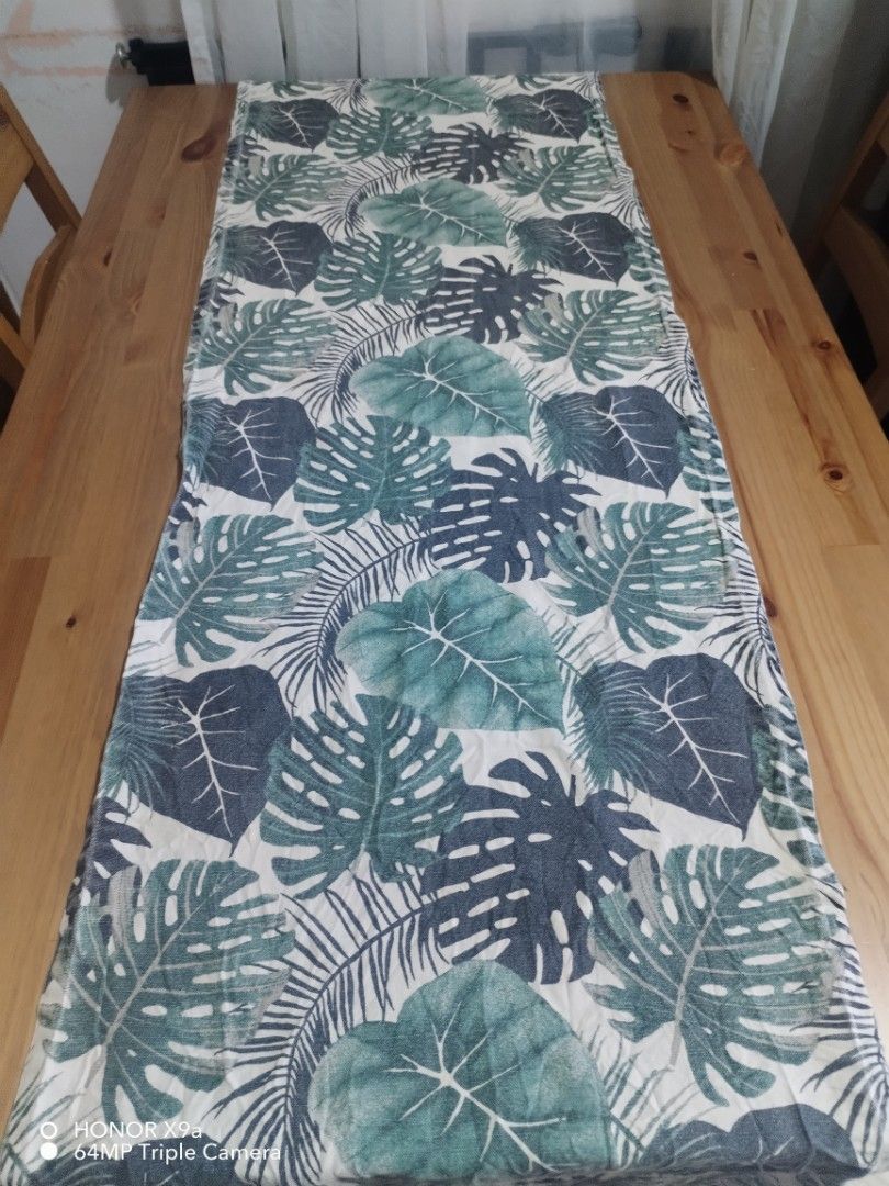 Table Runner ( Dahon design) (Category: Towels, Napkins & Holders) located in Muntinlupa City. Submitted by arciagamaryann68 (Listing ID 1467455474, Image 2). Description: - Item: Table Runner - Design: Tropical 'Dahon' (leaf) print - Color: Shades of green and dark grey on white/light background - Condition: Well-maintained and ready to use - Ideal for: Dining table decor, coffee table styling, or home aesthetic upgrade.