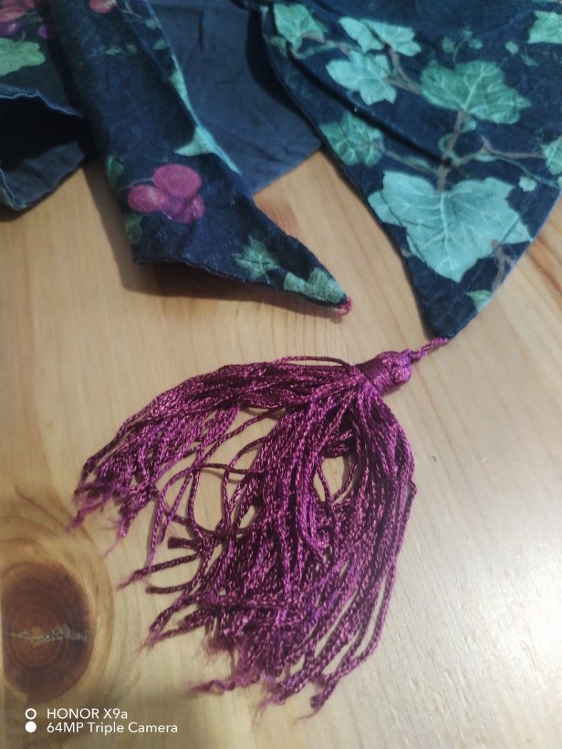 Table Runner ( missing one Palawit) (Category: Towels, Napkins & Holders) located in Muntinlupa City. Submitted by arciagamaryann68 (Listing ID 1467455119, Image 3). Description: - Color: Black base with purple grape clusters and green vine leaves - Feature: Elegant purple tassels on both ends for a classy finish - Material: Fabric table runner, great for dining setup or coffee tables - Condition: Excellent pre-loved condition, well-maintained - 