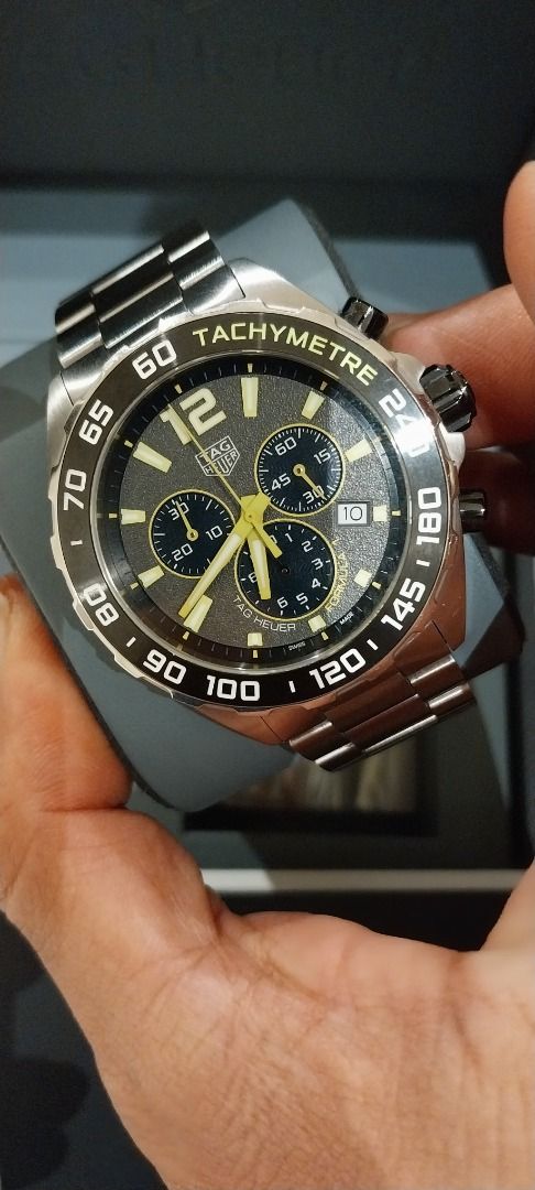 TAG Heuer Formula 1 Chronograph Watch (Category: Luxury Watches) located in Caloocan City. Submitted by hanna39597 (Listing ID 1467595542, Image 2). Description: - Brand/Model: TAG Heuer Formula 1 Chronograph - Dial: Black textured with luminous yellow hands and markers - Features: Tachymeter bezel and date window between 4 and 5 o'clock - Material: Durable stainless steel bracelet - Condition: Brand new with protective plastic film still on the 